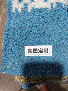 Detailed view of soft blue knitted fleece blanket fabric featuring a custom fabric label.