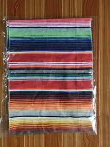 Detailed view of the Mexican style woven rainbow striped blanket, ideal for colorful decor.