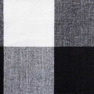 Close-up detail of classic black and white checkered fabric texture, clear weave pattern.