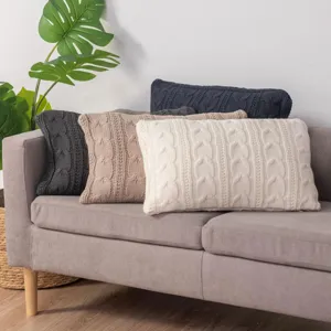 Detailed view of soft knitted cable throw pillow covers in assorted neutral colors for cozy living.