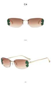 Vue rapprochée de lunettes de soleil sans monture avec verres dégradés et décorations de feuilles.