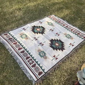 Ethnic geometric knitted throw blanket for sofa, bed, or outdoor picnic decor use.