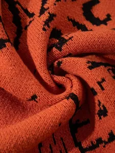 Primo piano dettagliato della texture del tessuto del cardigan in maglia arancione.