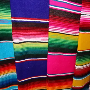Vibrant Mexican rainbow stripe fabric detail shot, perfect for bohemian DIY and party decor.