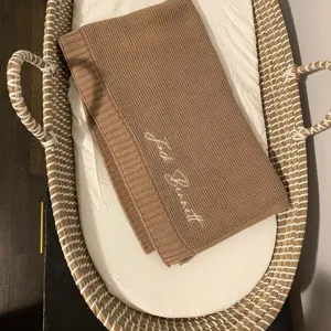 Knit baby blanket in brown color with custom embroidery detail, soft cotton winter warm cover.
