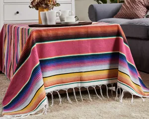 Detailed shot of Mexican style striped blanket showcasing vibrant ethnic colors and soft fringe.