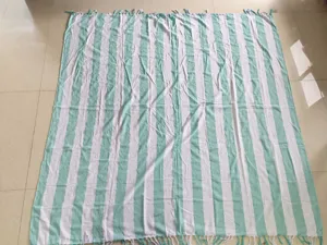 Close-up detail of the soft cotton Turkish striped beach towel with delicate decorative fringes.