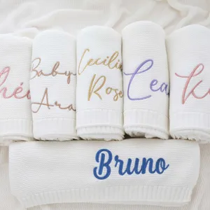 Customized baby knitted blanket detail showing embroidered name design and soft texture.