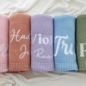 Personalized embroidered knit baby blanket soft cotton newborn swaddle throw for winter cozy use.
