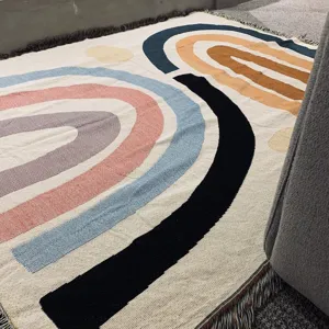Detailed view of Nordic knit blanket, abstract arch pattern fringe trim, cozy texture close up