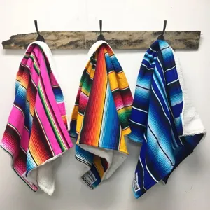 Detailed view of Mexican rainbow striped baby blanket with sherpa lining for daily nap use.
