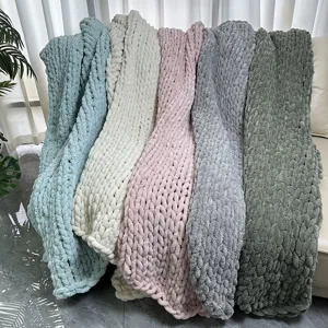 Detailed close-up view of hand-knitted chenille chunky yarn blankets in vibrant colors.