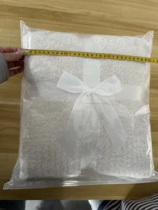 White flannel throw blanket with ribbon packaging for cozy winter home decor and sofa warmth