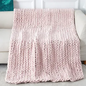 Chunky knit chenille throw blanket draped on a cozy sofa, soft texture home decor aesthetic.