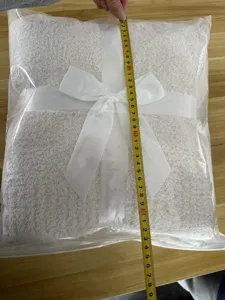 Solid color sherpa fleece blanket folded with white ribbon gift packaging for winter warmth