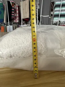 Close-up detail showing folded plush throw blanket thickness and texture in clear packaging.
