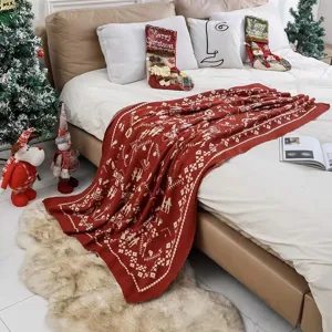 Red Christmas knitted throw blanket with festive jacquard pattern, cozy home decor sofa bed.