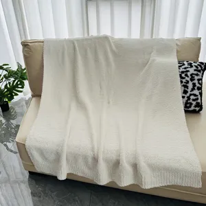 Cozy white fleece throw blanket detail, soft warm fluffy knit sofa cover for winter home decor.