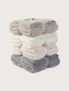 Cozy fuzzy plush throw blankets stack in multi colors for winter home living room sofa.
