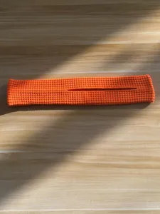 Orange knitted hair styling accessory, stylish daily fashion hair tool for women.