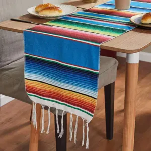 Mexican style colorful striped table runner detail view with woven fringes for home party decor.