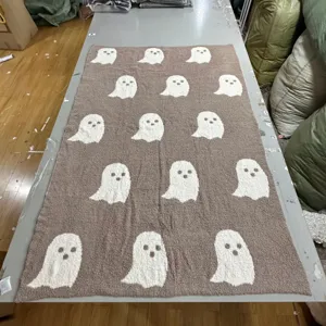 Brown ghost pattern fleece blanket detail shot, cozy soft throw blanket for winter home decor.