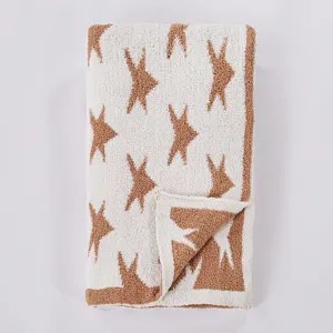 Detailed view of cozy plush knit star blanket, soft fuzzy texture for kids and home decor.