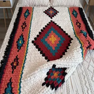 Handmade chunky knit blanket featuring a bohemian diamond pattern and cozy chenille texture.