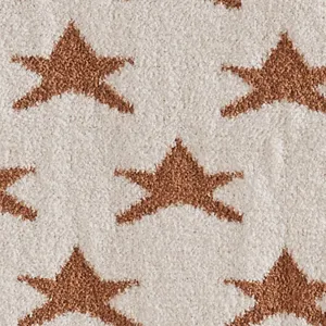 Close-up detail of soft fleece blanket with brown star pattern texture fabric