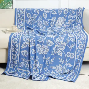 Blue and white woven floral jacquard throw blanket for cozy sofa, bed, and daily travel use.