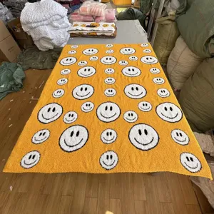 Yellow knitted jacquard fuzzy blanket with cute smiley face pattern, soft fleece throw rug.