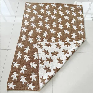 Gingerbread man pattern blanket detail, soft knitted fleece texture, cozy reversible design.