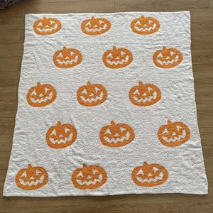 Detailed view of the soft knitted pumpkin jacquard blanket, showing cozy texture and cute design.