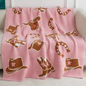 Cozy pink fuzzy throw blanket with cute cowboy hat and horseshoe knit pattern for living room.