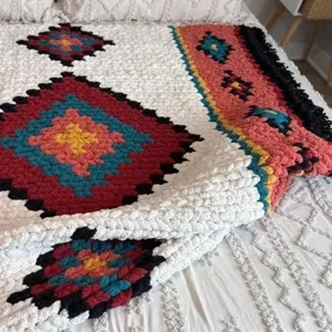 Ethnic style knitted blanket with geometric rhombus pattern and tassels for cozy home decor.