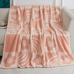 Pink and white fluffy smiley face blanket, cozy fleece throw for sofa and living room.