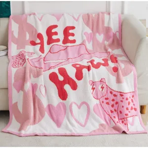Cozy pink knit plush throw blanket for sofa, soft fluffy decorative blanket with cute western design.