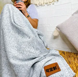 Cozy grey knitted blanket throw with custom leather label for autumn and winter home decor