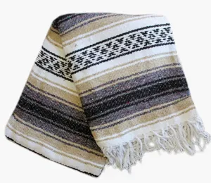 Close-up detail of the woven Mexican style geometric patterned fringe blanket for cozy home decor.