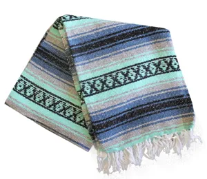 Mexican style woven blanket with geometric stripes and fringe for beach picnic home decor.
