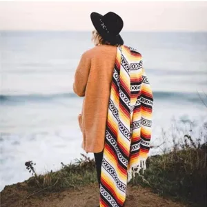 Mexican style geometric fringe blanket for beach picnic and home decor with vibrant colors.