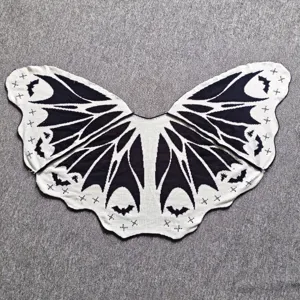 Detailed view of the black and white knitted bat wing shawl, perfect for Halloween styling.