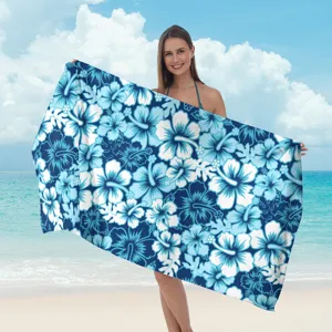 Telo mare in microfibra con motivo floreale tropicale blu e bianco per la spiaggia.