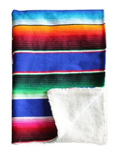 Mexican style colorful striped throw blanket featuring a cozy white sherpa lining.