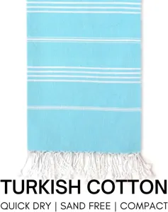 Turkish cotton beach towel detail showing light blue fabric, white stripes and tassels.