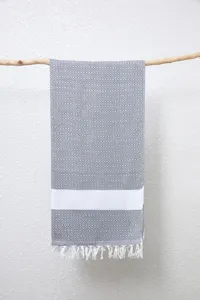 Detailopname van de Turkse geometrische jacquard katoenen strandhanddoek met franjes.