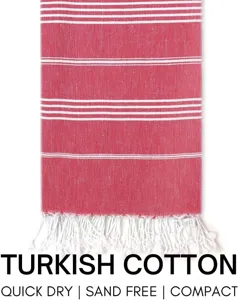 Detailed view of red white striped Turkish cotton beach towel with quick dry and fringe tassels.