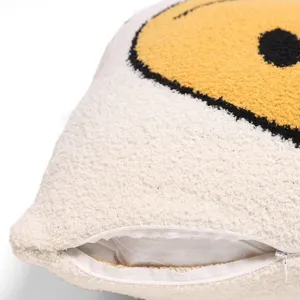 Close-up of fluffy sherpa pillowcase with cute smiley face jacquard and zipper detail.