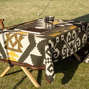 Outdoor camping style woven geometric blanket showcasing detailed ethnic tribal pattern texture setup.