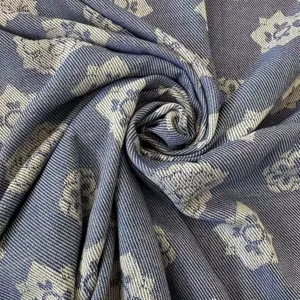 Close-up detail of blue jacquard woven summer blanket fabric showing soft texture and pattern.